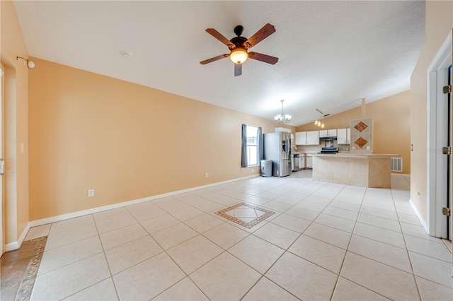 unfurnished living room with a textured ceiling, ceiling fan with notable chandelier, vaulted ceiling, and light tile patterned floors