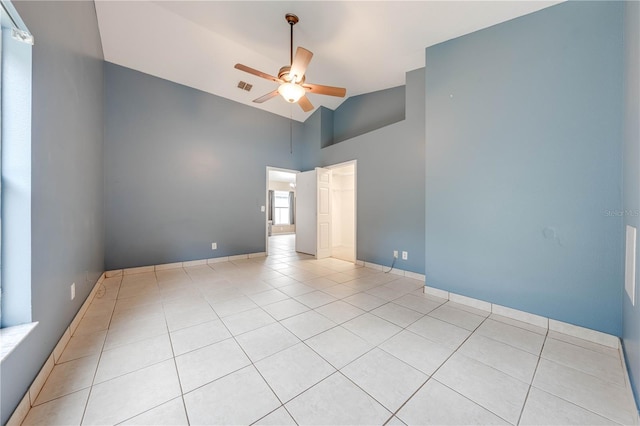 tiled empty room featuring high vaulted ceiling and ceiling fan