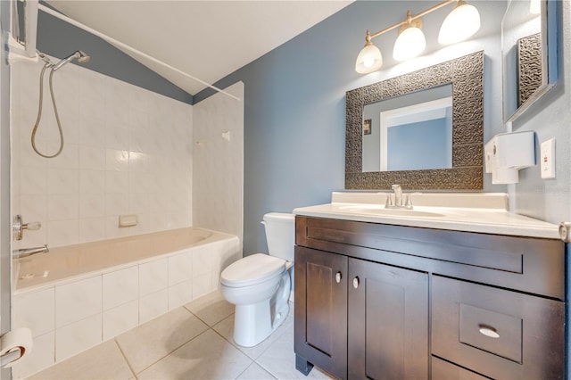 full bathroom featuring lofted ceiling, vanity, tiled shower / bath, toilet, and tile patterned floors