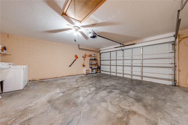 garage featuring a garage door opener and washing machine and clothes dryer