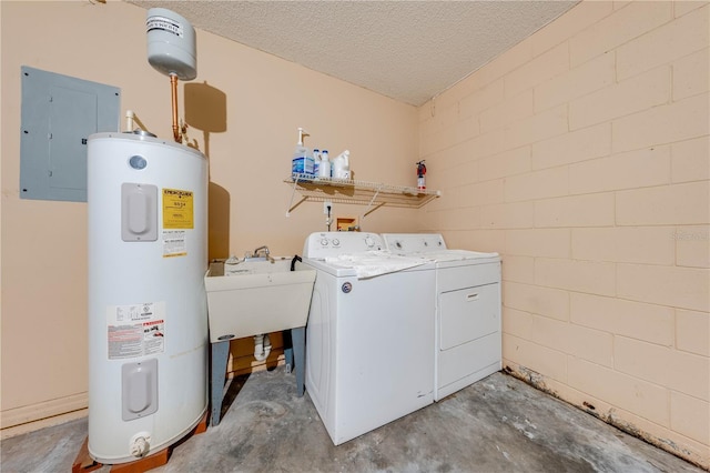 washroom with electric water heater, washer and clothes dryer, a textured ceiling, electric panel, and sink