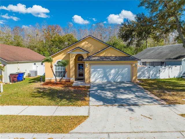 view of front of house with central air condition unit, a front yard, and a garage