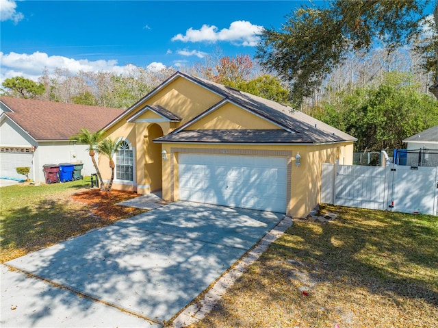 view of front of property featuring a front lawn and a garage