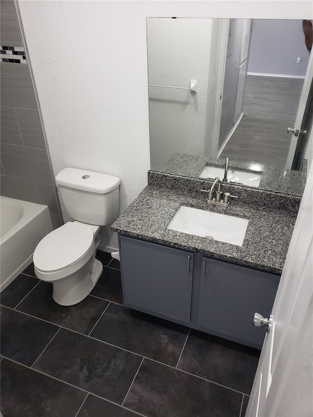 bathroom with tile patterned flooring, vanity, and toilet