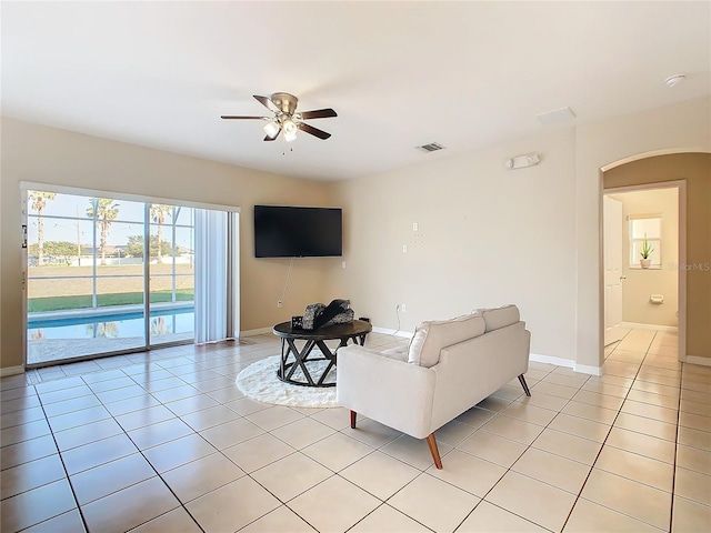 living room featuring ceiling fan and light tile patterned floors