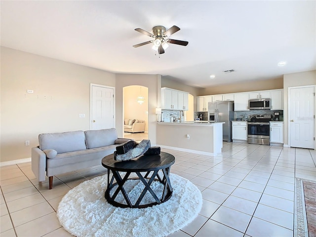 tiled living room featuring ceiling fan