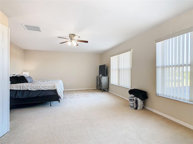 bedroom with ceiling fan and light carpet