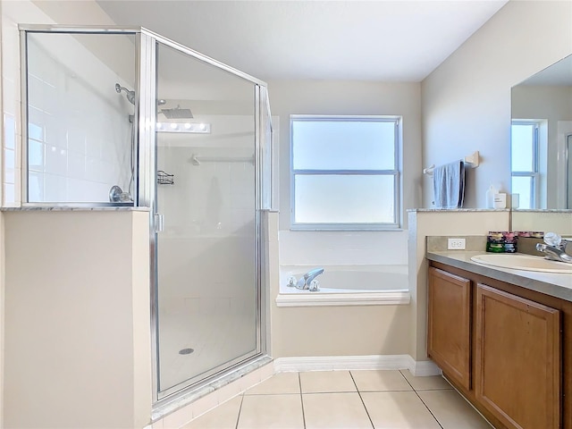 bathroom featuring tile patterned flooring, vanity, and plus walk in shower