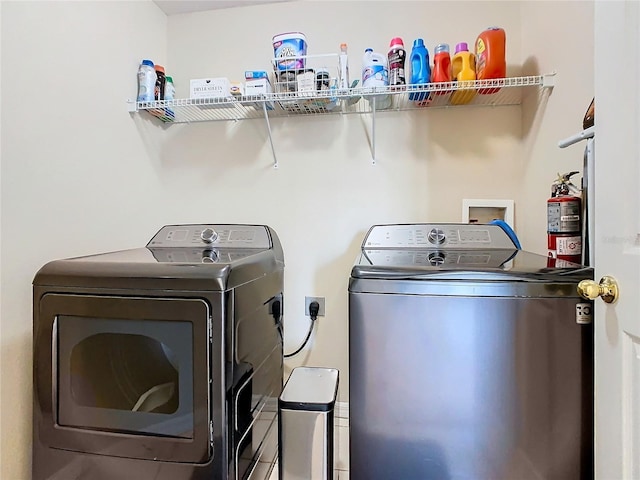 clothes washing area with separate washer and dryer