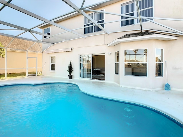 view of pool with glass enclosure