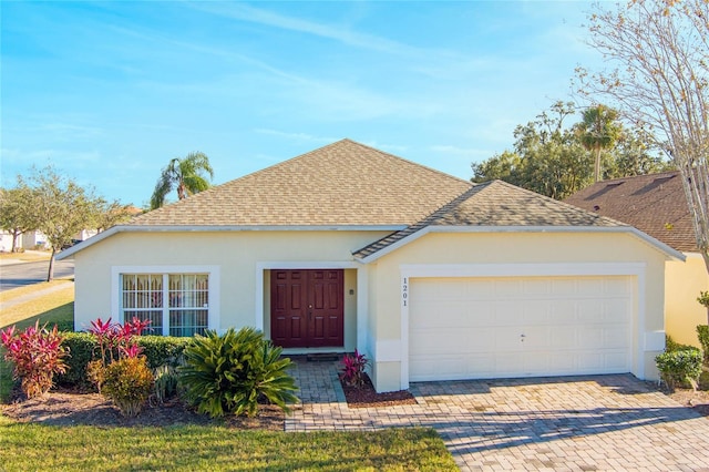 view of front of home featuring a garage and a front lawn