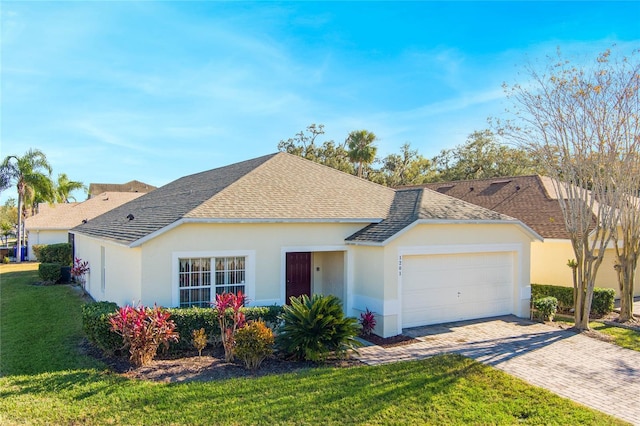 ranch-style home featuring a front yard and a garage