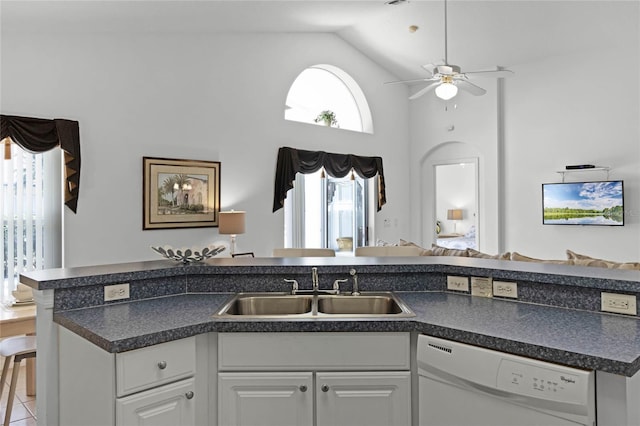 kitchen with lofted ceiling, white cabinets, white dishwasher, sink, and ceiling fan