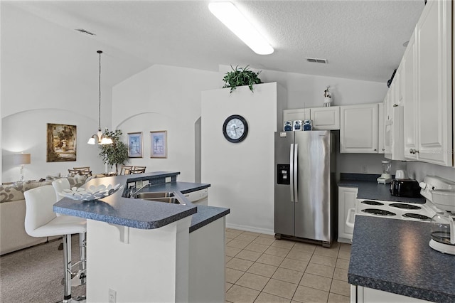 kitchen with white cabinets, pendant lighting, white appliances, and lofted ceiling