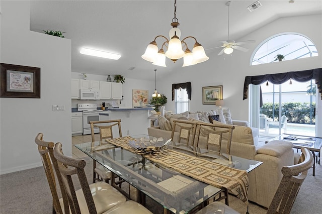 dining room with lofted ceiling, light colored carpet, and ceiling fan with notable chandelier