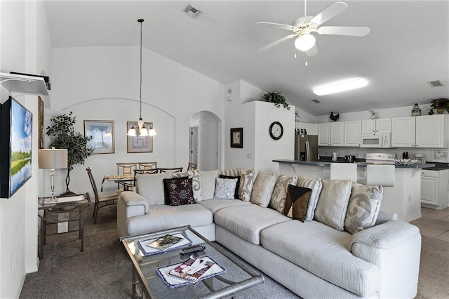 living room with carpet, ceiling fan with notable chandelier, and lofted ceiling