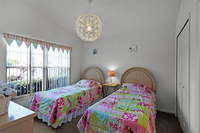 carpeted bedroom with an inviting chandelier, a closet, and lofted ceiling