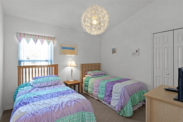 bedroom featuring carpet, a chandelier, and a closet