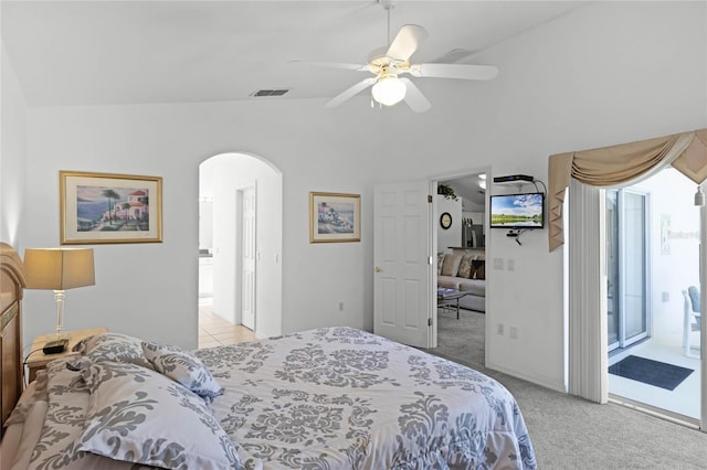 carpeted bedroom with ceiling fan, access to exterior, ensuite bath, and vaulted ceiling