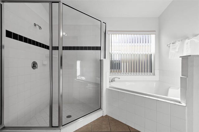 bathroom featuring tile patterned floors and shower with separate bathtub