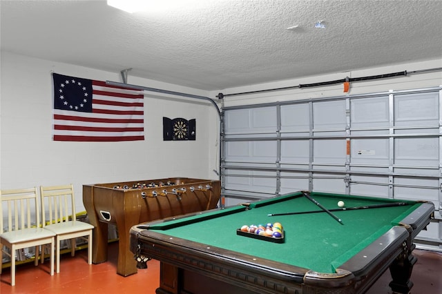 playroom with concrete flooring, a textured ceiling, and billiards