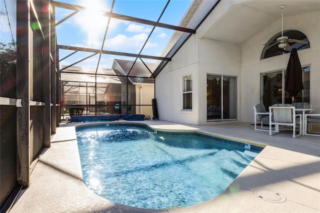 view of pool featuring a patio, ceiling fan, and a lanai