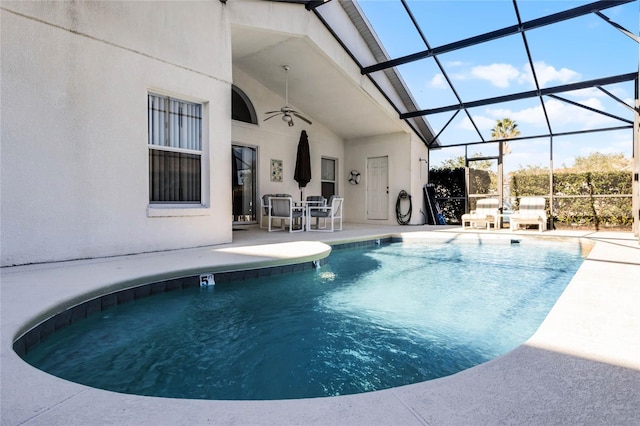 view of pool featuring ceiling fan, a lanai, and a patio