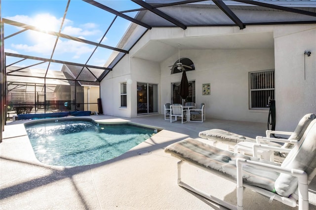 view of pool featuring glass enclosure and a patio