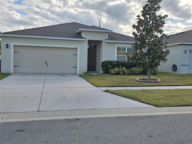 view of front of property with a garage and a front yard