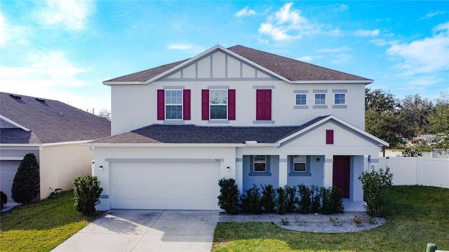 view of front of property with a front yard and a garage