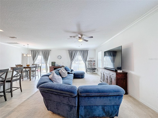 carpeted living room with ceiling fan with notable chandelier, a healthy amount of sunlight, ornamental molding, and a textured ceiling