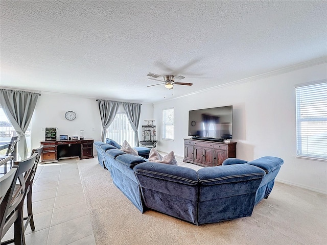 tiled living room featuring ceiling fan, crown molding, and a textured ceiling