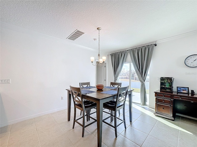 tiled dining space featuring crown molding, a textured ceiling, and a chandelier