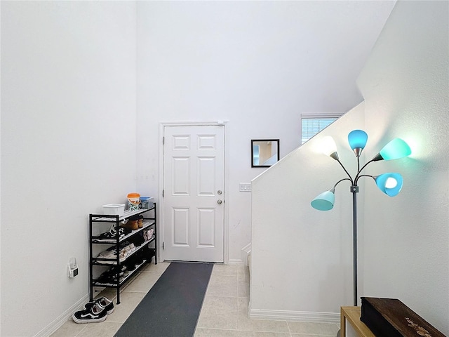 misc room featuring light tile patterned floors and an inviting chandelier