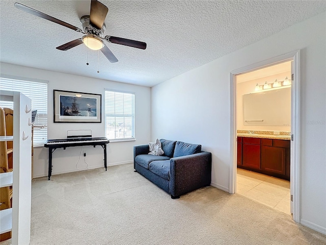 carpeted living room with a textured ceiling and ceiling fan