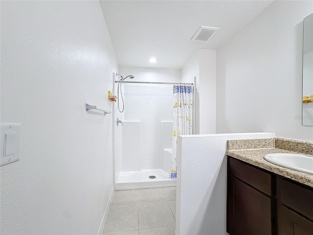 bathroom with a shower with shower curtain, vanity, and tile patterned flooring