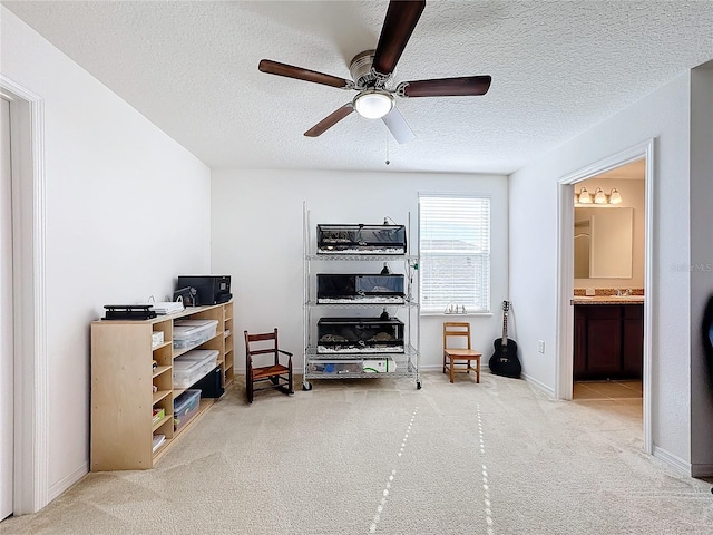 interior space with carpet flooring, ceiling fan, and a textured ceiling