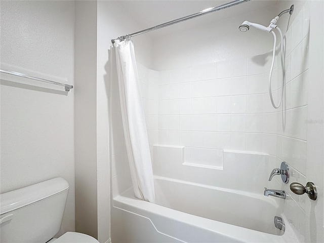 bathroom featuring toilet and shower / tub combo with curtain