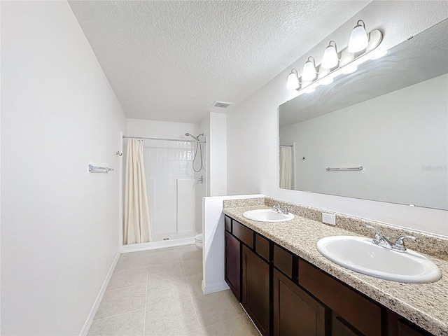 bathroom with tile patterned floors, a textured ceiling, toilet, vanity, and a shower with shower curtain