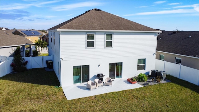 rear view of house with a yard, central AC unit, and a patio area