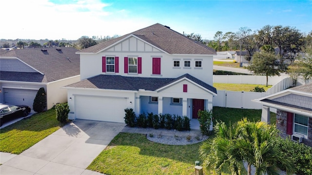 view of front of property with a front yard and a garage