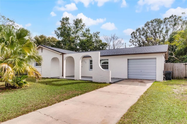 single story home with a front yard and a garage