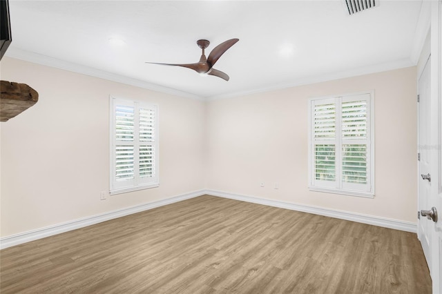 empty room with ceiling fan, ornamental molding, and light hardwood / wood-style floors