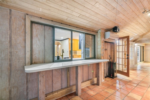 bar featuring french doors, lofted ceiling, wood ceiling, wooden walls, and a wall unit AC