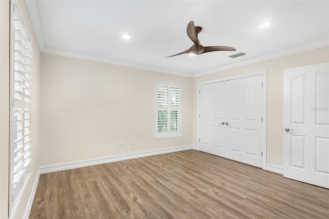 unfurnished bedroom featuring crown molding, a closet, ceiling fan, and light hardwood / wood-style flooring