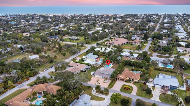 aerial view at dusk with a water view