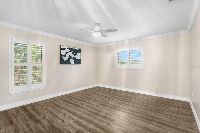 empty room with a wealth of natural light, ornamental molding, dark hardwood / wood-style floors, and ceiling fan