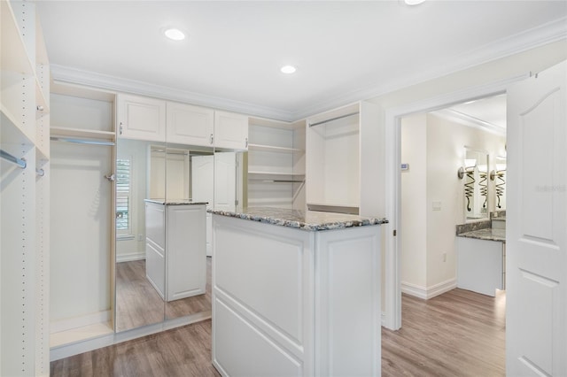 spacious closet featuring light hardwood / wood-style floors