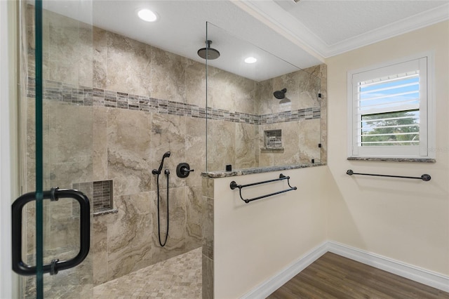 bathroom with ornamental molding, an enclosed shower, and hardwood / wood-style floors