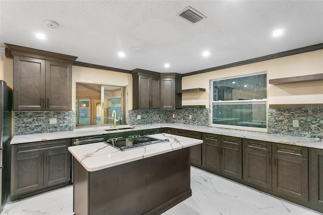 kitchen featuring appliances with stainless steel finishes, sink, ornamental molding, a center island, and dark brown cabinets